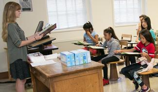 Madison Garrett leads a group of Cleveland Road Elementary School students in a writing exercise